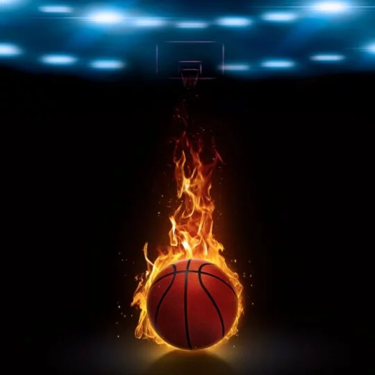 A basketball with flames in front of a dark arena. Player. Team. Teamwork. 